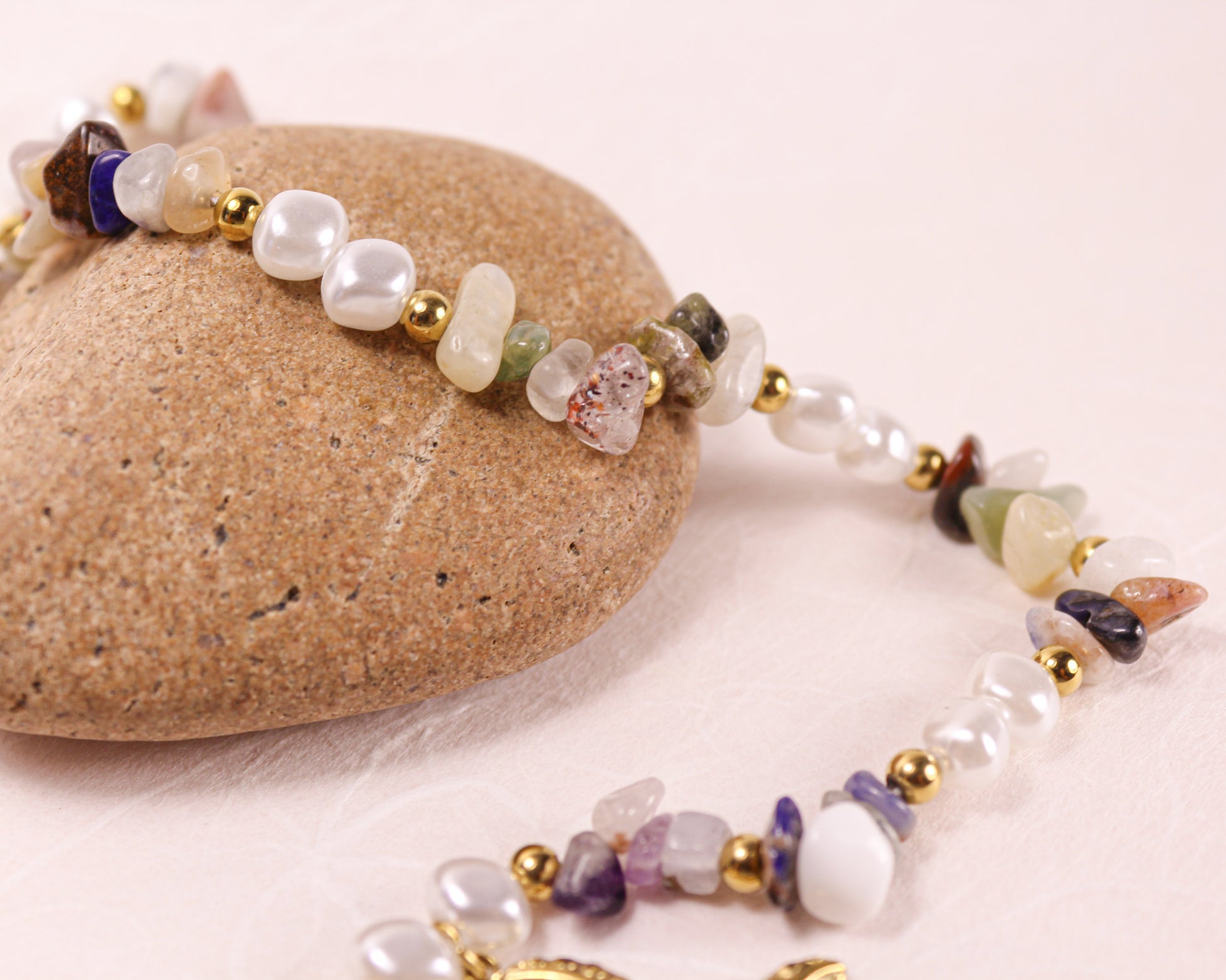 Beaded necklace with multicolored beads on a stone surface